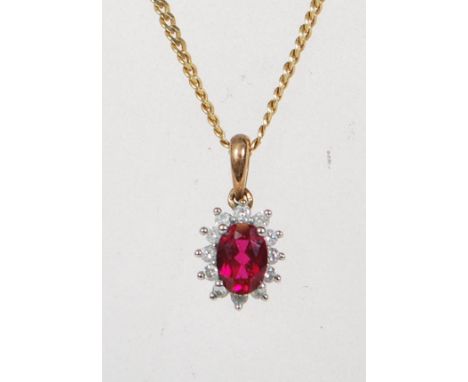 A 9ct yellow gold, diamond and ruby pendant with necklace chain. The flat link chain with single drop pendant having round cu