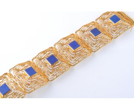 A mid century 14ct gold and lapis lazuli bracelet. The bracelet having six oversized architectural links in a textured openwo