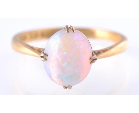 A hallmarked 22ct gold opal cabochon ring. The ring being set with an opal cabochon within a collet and prong setting. The op