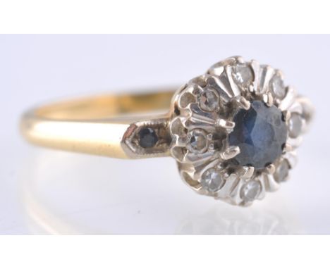 A&nbsp; hallmarked 18ct gold sapphire and diamond cluster ring. The ring having a central round mixed cut sapphire surrounded