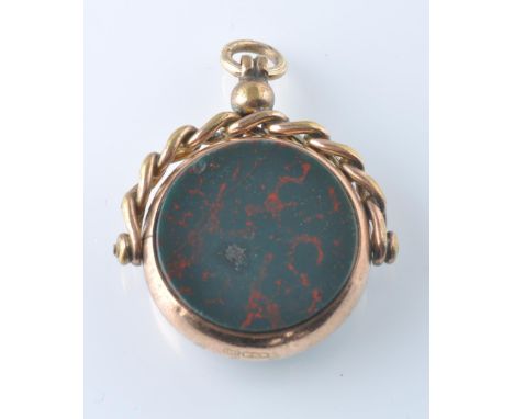 A Victorian gold swivel fob. The fob set with bloodstone and carnelian plaques within a gold case with fixed chain style swiv