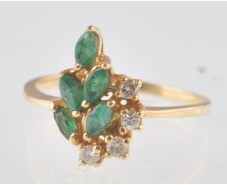 A 14ct gold, diamond and emerald ring. Marquise cut emeralds set with 4 round cut diamonds. Total weight 2.36g / Size M.5