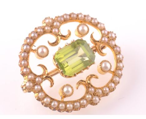 A late 19th century 15ct gold Belle Epoque pearl and peridot brooch pin. The brooch having an openwork design with collet set
