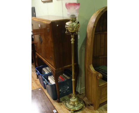 Edwardian polished brass standard oil lamp with reeded stem and circular base, Victor burner with later shade