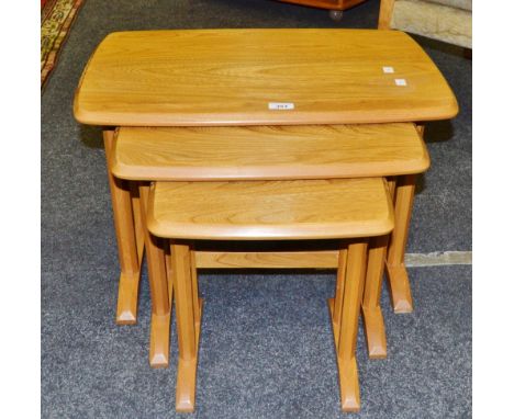 An Ercol nest of three graduated coffee tables, coffee bean carved decoration