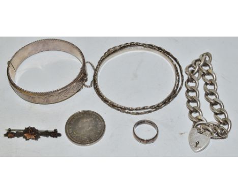 A silver bracelet, heart locket;  silver hinged bangle;  others;  a silver horseshoe and ivy brooch