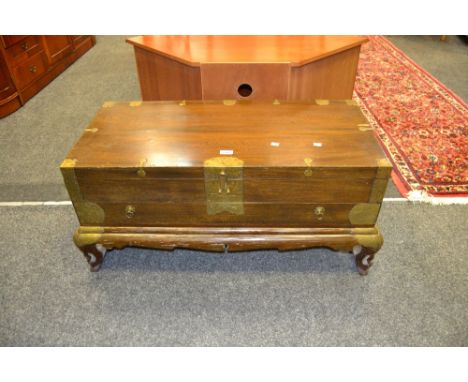 An oriental trunk on stand, single drawer, carved feet, brass edging 