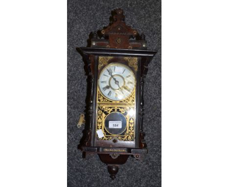 A 20th century wall clock, Roman numerals, eight day movement striking on a bell, twin winding holes