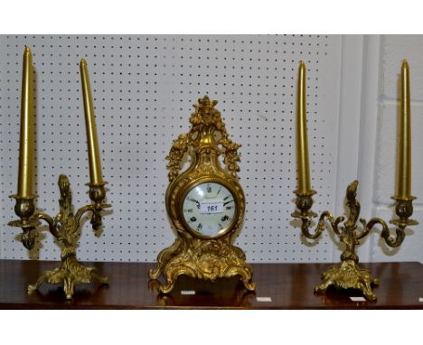 A Louis XVI style Imperial mantel clock, gilt decoration; a pair of gilt two light candle stick holders