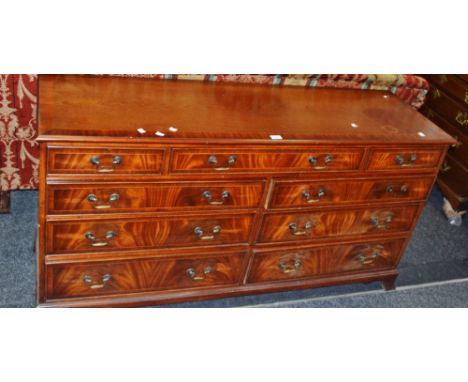 A 20th century sideboard,  one large cockbeaded drawer, flanked by two smaller,  over six drawers, bracket feet,  152cm x 77c
