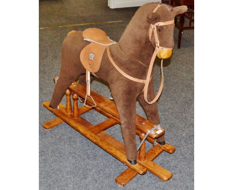A Mama's and Papa's Rocking horse, leather saddle and bridle