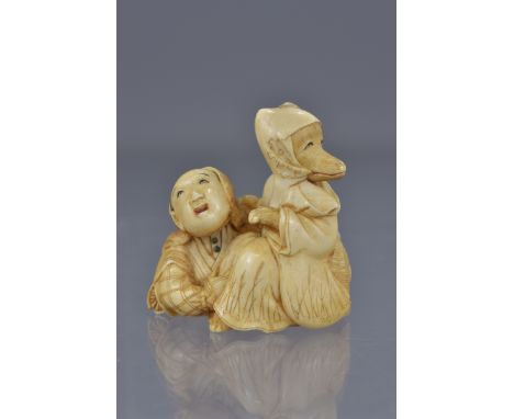 A Japanese Meiji period carved ivory netsuke of a Samurai and fox-priest Hakusôzu. 4cm x 4cm 