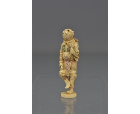 An early 20th century carved ivory netsuke of a monkey. 7cm tall 