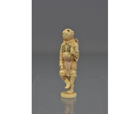 An early 20th century carved ivory netsuke of a monkey. 7cm tall 