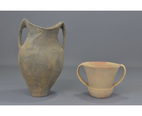 Two Chinese Neolithic period pottery jars with twin handles. Smaller pot with damaged handle. 12cm tall and 26cm tall   Prove