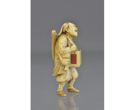 A fine Japanese Meiji period carved ivory netsuke of a street vendor signed. 5cm tall 