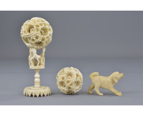 Selection of early 20th century ivory items. Including two Chinese puzzle balls (one with stand) and a carved ivory dog. 