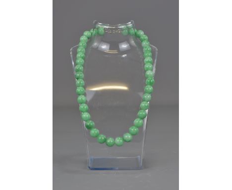 A string of 38 jade beads in a necklace.