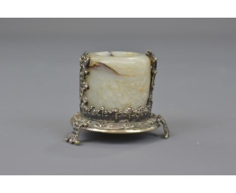 A Chinese carved jade archer's ring mounted with silver. 3 cm. 