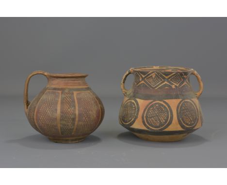Two Chinese Neolithic period pottery pots with handles. 13cm tall and 11.5cm tall    Provenance: From a respectable family in