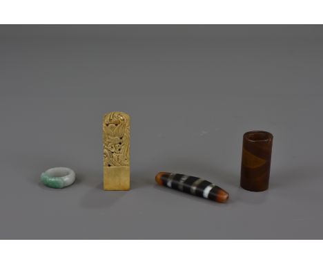 A Chinese 20th century soapstone seal, two agate beads together with a jadeite ring.