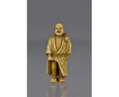 A Japanese Meiji period carved ivory netsuke of a bather in sandals. 5cm tall 