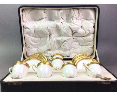 ROYAL WORCESTER, A SET OF SIX DEMI TASSE CUPS AND SAUCERS each piece bordered with gilt, in original fitted casethe case 38.5
