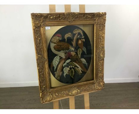VICTORIAN WOOLWORK PANEL depicting a parrot perched on a branchmounted, framed and under glassThe overall size 64cm x 74cm. O