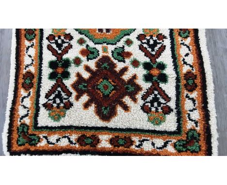 VINTAGE DESIGN WOOL RUG decorated with geometric designs on a cream ground168cm X 90cm