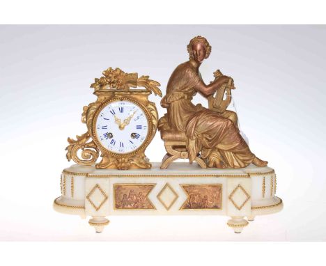 Victorian gilt metal and marble mantel clock with circular movement beside harpist figure