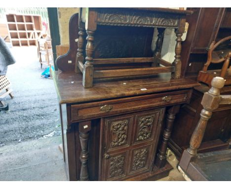 A 98cm late Victorian oak chiffonier with profuse carved decoration to raised back, single frieze drawer ad double cupboard u