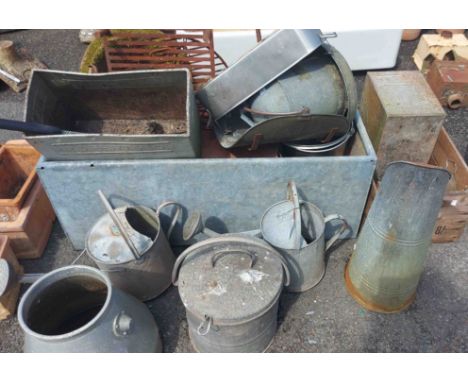 A large galvanised metal water trough - sold with a quantity of metal watering cans and other items