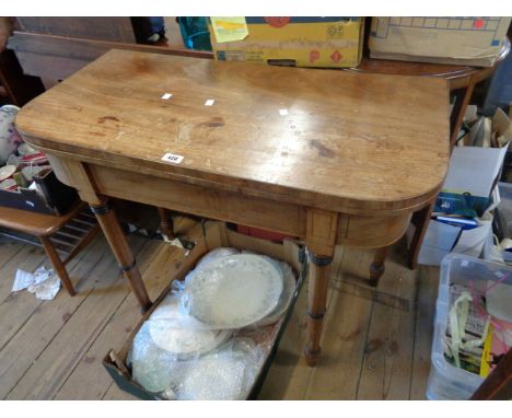 A 92cm Victorian mahogany fold-over card table with green baise lined interior and double gated action, set on ring turned le