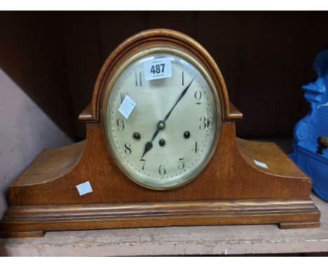 A large vintage oak cased Napoleon hat mantel clock with Arabic numerals and Junghans eight day chiming movement