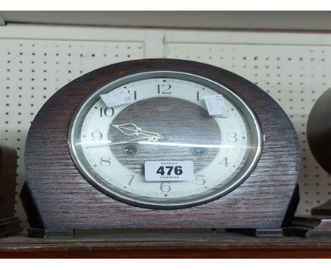 A vintage Smiths oak cased mantel clock with eight day gong striking movement
