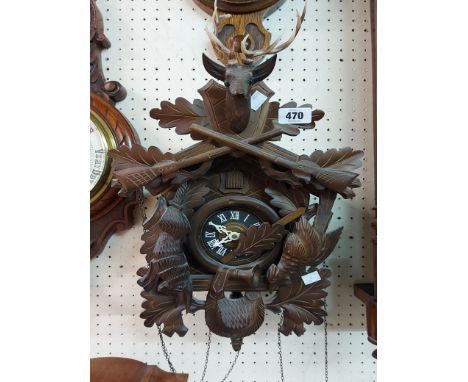 A vintage stained wood and resin cased cuckoo clock with deer head pattern pediment, further applied decoration and twin weig