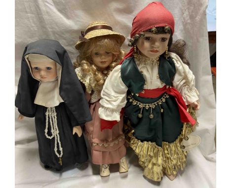 Three vintage porcelain dolls comprising a nun, Gypsy Rose and another