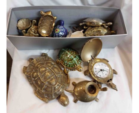 A box containing a large quantity of brass tortoise figurines of various design and function including candlestick, etc.