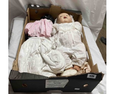 A box containing two vintage composition dolls - sold with extra items of clothing