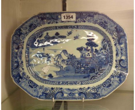 An antique Chinese porcelain meat plate, with blue hand painted Willow pattern decoration