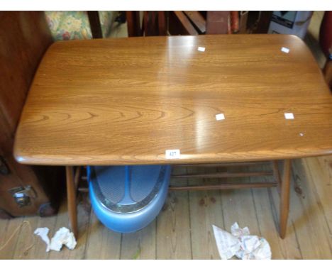 A 100cm vintage Ercol elm coffee table, set on turned supports with undertier