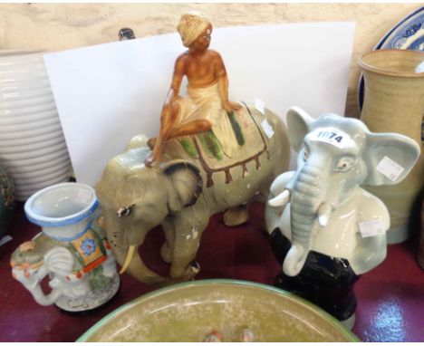 A vintage plaster figurine, depicting an elephant and rider - sold with a ceramic elephant form money box and a planter - var