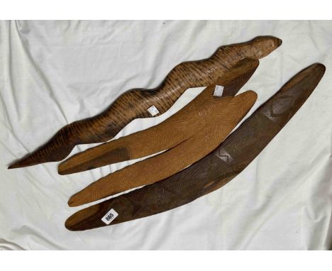 Three old Aboriginal Australian wooden hunting boomerangs and a fighting stick in the form of a snake