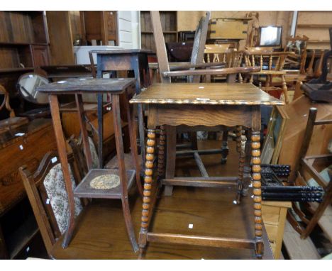 An early 20th Century oak occasional table, set on bobbin turned supports - sold with another similar and two jardinière stan