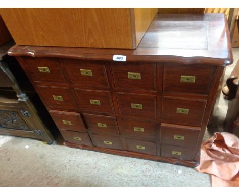 A 75cm modern stained hardwood CD storage chest with sixteen fitted drawers, each with brass flush drop handles, set on plint