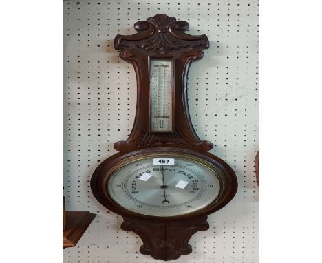 An early 20th Century carved mahogany framed banjo barometer/thermometer with silvered dial marked for F. Barker &amp; Son, L