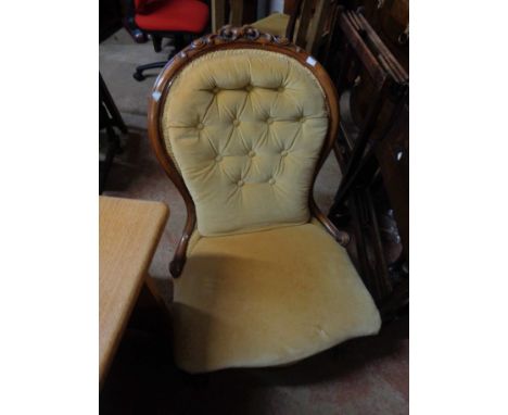 A Victorian mahogany show frame drawing room chair with button back old gold velour upholstery, set on cabriole front legs wi