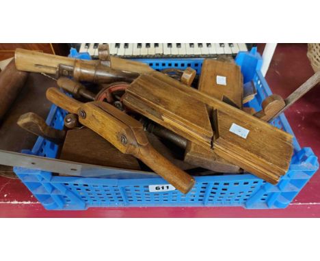 A crate containing a quantity of woodworking tools including planes, hand vices, etc.