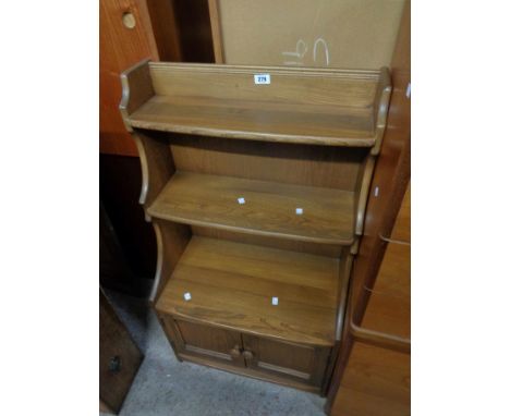 A 60cm Ercol dark elm three shelf waterfall open bookcase with double cupboard under, set on plinth base