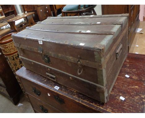 An 85cm old wood bound and weather coated travelling trunk with iron strapping and flanking handles - sold with a small mahog